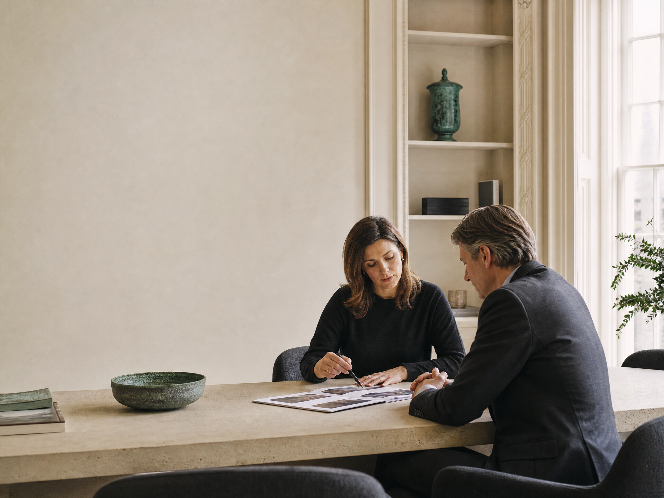 Advisers reviewing a portfolio in a quiet office